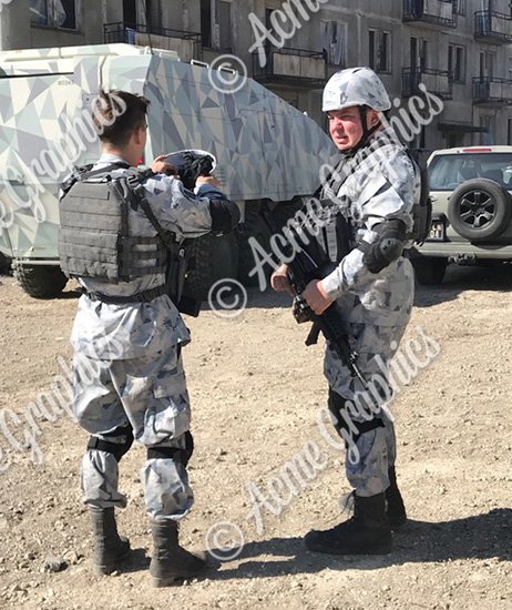 Extras in military uniforms in front of troop carrier